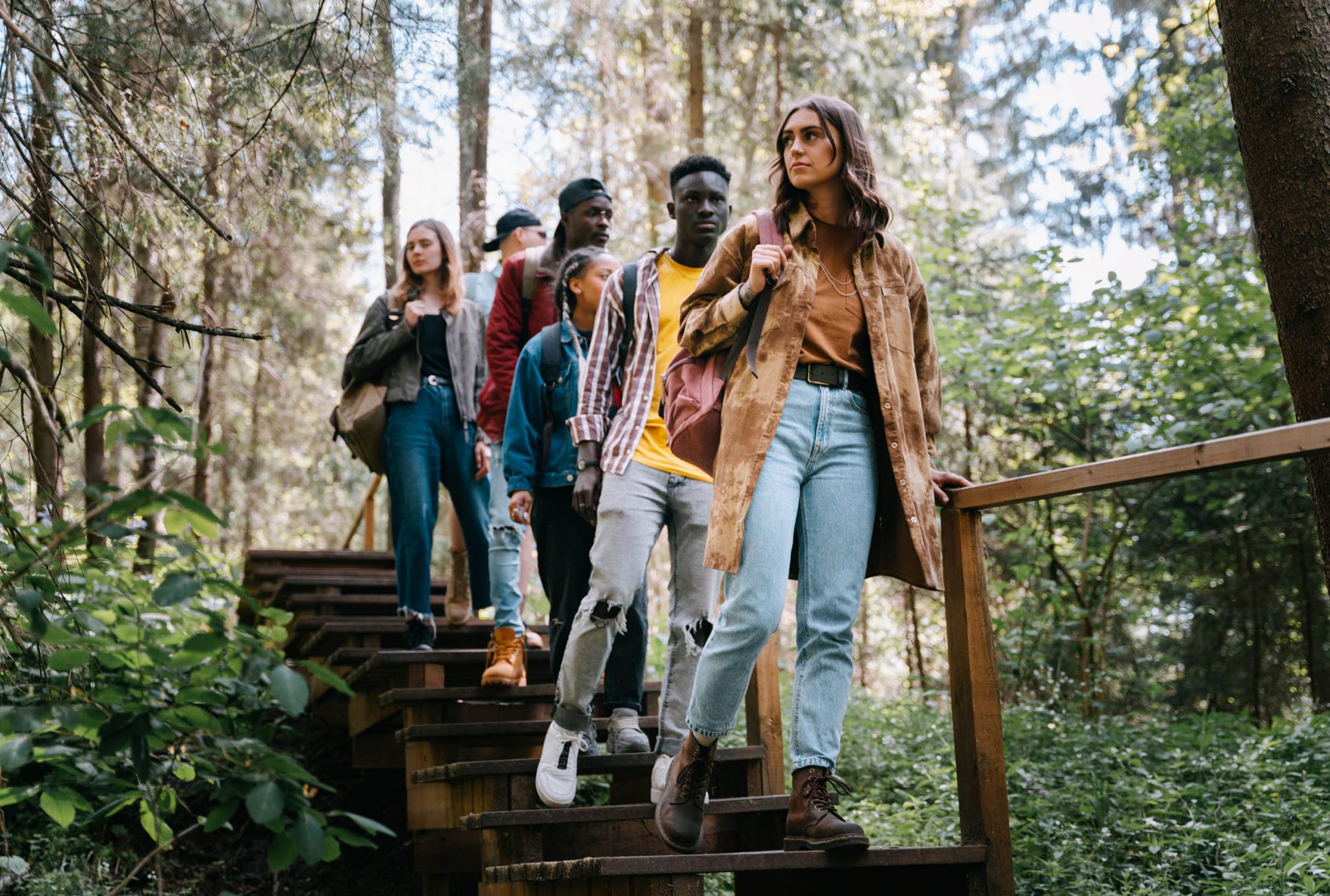 College friends walking together on a nature trail